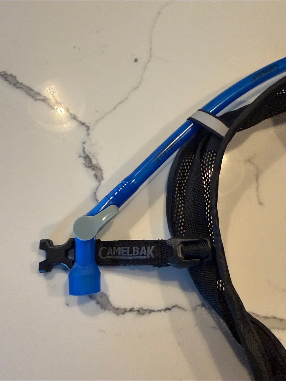 Camelbak Black Hydration Pack with Blue Drinking Tube